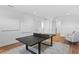 Game room features a ping pong table, hardwood flooring, and access to other areas of the home at 4536 W Swann Ave, Tampa, FL 33629