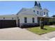 Side view of a well maintained house featuring a two-car garage and a paved driveway at 4536 W Swann Ave, Tampa, FL 33629