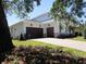 Side view of a well maintained house featuring a two-car garage and a paved driveway at 4536 W Swann Ave, Tampa, FL 33629