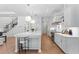 Bright and airy kitchen featuring white cabinets, a large island with seating, and stainless steel appliances at 4536 W Swann Ave, Tampa, FL 33629