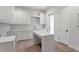 Bright kitchen featuring white cabinets, modern countertops, and a stylish island, perfect for cooking at 4536 W Swann Ave, Tampa, FL 33629