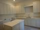 Kitchen featuring white cabinets, stone countertops, and a center island at 4536 W Swann Ave, Tampa, FL 33629