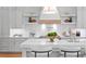 A modern kitchen features a large island, custom cabinets, and stylish decor at 4536 W Swann Ave, Tampa, FL 33629