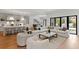 Bright, open-concept living room with a gourmet kitchen, comfortable seating, and sliding doors to the outdoor area at 4536 W Swann Ave, Tampa, FL 33629