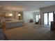 Open-concept living space with kitchen and adjacent space with large windows at 4536 W Swann Ave, Tampa, FL 33629