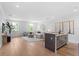 Open concept living area featuring hardwood floors, modern decor and wet bar with seating at 4536 W Swann Ave, Tampa, FL 33629