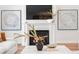 Inviting living room featuring a fireplace, decorative artwork, and a coffee table styled with books and accessories at 4536 W Swann Ave, Tampa, FL 33629