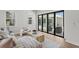 Cozy living room with views of outdoor lounge area through folding glass doors at 4536 W Swann Ave, Tampa, FL 33629
