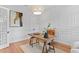 Elegant office with natural wood desk, hardwood floors, modern lighting fixture, and paneled walls at 4536 W Swann Ave, Tampa, FL 33629