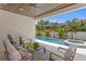 Inviting covered patio with comfortable seating overlooking a sparkling pool and lush tropical landscaping at 4536 W Swann Ave, Tampa, FL 33629