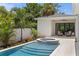 Beautiful pool with a jacuzzi and seating area surrounded by lush landscaping and privacy fence at 4536 W Swann Ave, Tampa, FL 33629