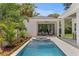 Backyard pool featuring a spa, outdoor seating area, and beautiful landscaping perfect for relaxation and entertainment at 4536 W Swann Ave, Tampa, FL 33629
