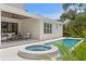 Backyard featuring a pool, spa, and covered patio area, perfect for outdoor living and entertaining at 4536 W Swann Ave, Tampa, FL 33629