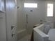 Spacious walk-in shower with multiple showerheads and a built-in seat at 4536 W Swann Ave, Tampa, FL 33629