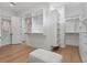 Large walk-in closet with custom shelving, ample storage, and wood floors at 4536 W Swann Ave, Tampa, FL 33629