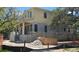A two-story home with grey brick and yellow wood exterior, showcases the under-construction property at 610 Ontario Ave, Tampa, FL 33606