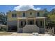 Two-story home under construction with a brick foundation, covered porch, and light yellow siding at 610 Ontario Ave, Tampa, FL 33606