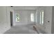 Bright, unfinished living room featuring new wall trim and large windows providing ample natural light at 610 Ontario Ave, Tampa, FL 33606