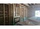 Unfinished fireplace and exposed wooden frame in a new living room, construction materials on the floor at 610 Ontario Ave, Tampa, FL 33606