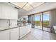 Kitchen with white cabinets and access to balcony at 6218 Palma Del Mar S Blvd # 606, St Petersburg, FL 33715