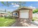 House exterior with white garage door and stone accents at 205 Se Monroe N Cir, St Petersburg, FL 33703
