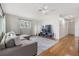 Living room with hardwood floors, sectional sofa, and large TV at 205 Se Monroe N Cir, St Petersburg, FL 33703