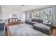Spacious living room with hardwood floors and L-shaped sectional sofa at 205 Se Monroe N Cir, St Petersburg, FL 33703