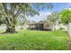 Large backyard with screened patio and lush lawn at 205 Se Monroe N Cir, St Petersburg, FL 33703