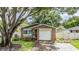 House exterior with white garage door and stone accents at 205 Se Monroe N Cir, St Petersburg, FL 33703