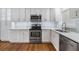 Bright kitchen boasts stainless steel appliances and white cabinets at 205 Se Monroe N Cir, St Petersburg, FL 33703