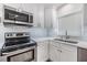 Modern kitchen with stainless steel appliances and white cabinets at 205 Se Monroe N Cir, St Petersburg, FL 33703