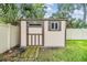 Tan storage shed with brown trim and wood flooring at 205 Se Monroe N Cir, St Petersburg, FL 33703