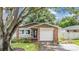 House exterior with white garage door and stone accents at 205 Se Monroe N Cir, St Petersburg, FL 33703