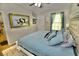 Comfortable main bedroom with a king-size bed and plenty of natural light at 36121 Lake Chase Blvd # 204, Zephyrhills, FL 33541