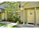 Tan two-story townhome with a light beige door at 36121 Lake Chase Blvd # 204, Zephyrhills, FL 33541