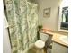 Clean bathroom with a shower/tub combo, updated fixtures, and a decorative shower curtain at 36121 Lake Chase Blvd # 204, Zephyrhills, FL 33541