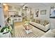 Open living room and kitchen with a beige couch at 36121 Lake Chase Blvd # 204, Zephyrhills, FL 33541