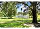 Landscaped pond with fountain, surrounded by lush greenery at 36121 Lake Chase Blvd # 204, Zephyrhills, FL 33541