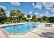 Community pool with lounge chairs and seating at 36121 Lake Chase Blvd # 204, Zephyrhills, FL 33541