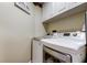 Convenient laundry room with front-load washer and dryer, and ample cabinet space at 11426 Glenmont Dr, Tampa, FL 33635