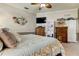 King-size bed in a spacious main bedroom with ensuite bathroom at 11426 Glenmont Dr, Tampa, FL 33635