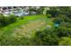 An aerial view of a large empty lot next to homes and a golf course at 11426 Glenmont Dr, Tampa, FL 33635