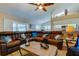 Spacious living room featuring a large sectional sofa and a view into the kitchen at 11426 Glenmont Dr, Tampa, FL 33635