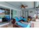 Covered patio features comfortable seating, a ceiling fan, and access to the pool area at 11426 Glenmont Dr, Tampa, FL 33635