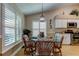 Casual dining area with a round table and four chairs, near the kitchen at 11426 Glenmont Dr, Tampa, FL 33635