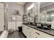 Bathroom with double vanity, black soaking tub, and shower at 11426 Glenmont Dr, Tampa, FL 33635