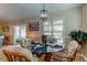 Charming dining area with a glass-top table and wicker chairs, near sliding doors at 11426 Glenmont Dr, Tampa, FL 33635