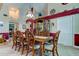 Open dining room with a large wooden table and six chairs at 11426 Glenmont Dr, Tampa, FL 33635