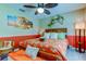 Bedroom with orange bedding and beach decor at 11426 Glenmont Dr, Tampa, FL 33635