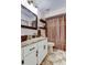 Updated bathroom features granite countertops, a large mirror, and a shower with a curtain at 11426 Glenmont Dr, Tampa, FL 33635